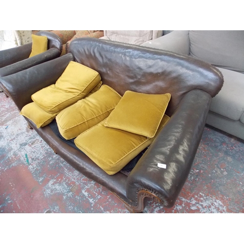 391 - A 1950'S BROWN LEATHER TWO SEATER SOFA WITH MATCHING ARM CHAIR