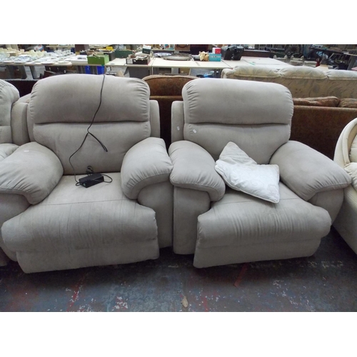 393 - A BEIGE UPHOLSTERED THREE SEATER SOFA WITH TWO MATCHING ELECTRIC RECLINING ARM CHAIRS