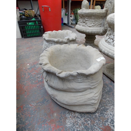 94 - TWO LARGE RECONSTITUTED STONE SACK GARDEN PLANTERS