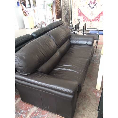 379A - A BROWN LEATHER THREE SEATER SOFA WITH TWO BLACK CHROME CHAIRS