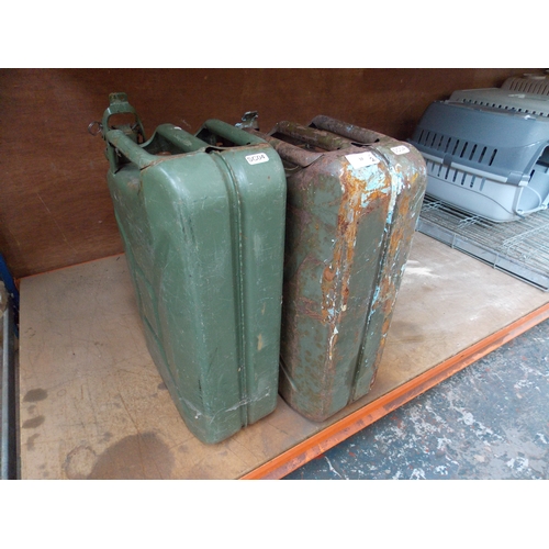 30 - A PAIR OF BLACK PLASTIC HGV WHEEL ARCHES AND TWO GREEN METAL ARMY STYLE 20 LITRE JERRY CANS