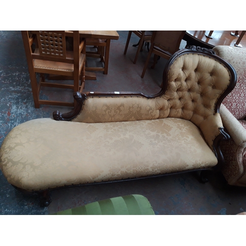 1228 - A VICTORIAN MAHOGANY FRAMED CHAISE LONGUE WITH CREAM FLORAL UPHOLSTERY, CARVED BALL AND CLAW FEET AN... 