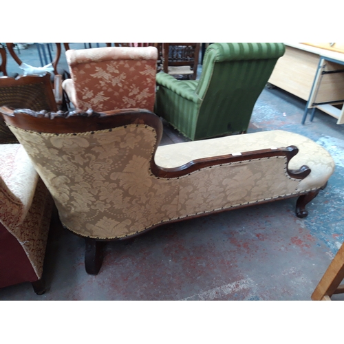 1228 - A VICTORIAN MAHOGANY FRAMED CHAISE LONGUE WITH CREAM FLORAL UPHOLSTERY, CARVED BALL AND CLAW FEET AN... 