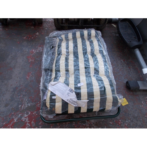 26 - A BAGGED GREEN METAL SUN LOUNGER WITH STRIPED UPHOLSTERY