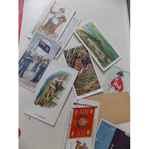 317 - A BASKET CONTAINING VARIOUS CIGARETTE CARDS