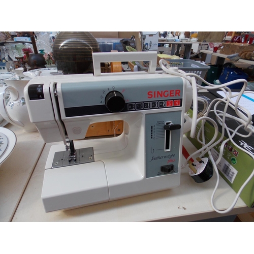 318 - A SEWING BOX WITH CONTENTS AND A CASED SINGER FEATHERWEIGHT PLUS ELECTRIC SEWING MACHINE