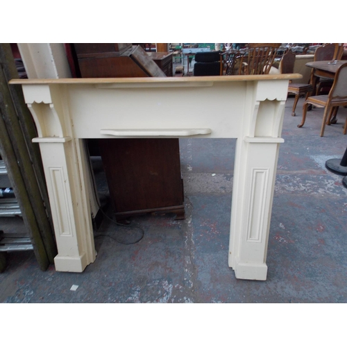 34 - A PAINTED PINE FIRE SURROUND MEASURING APPROX 4'4 X 3'8