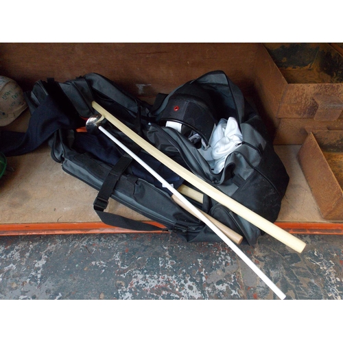 51 - A BAG CONTAINING FENCING EQUIPMENT TO INCLUDE HELMET, JACKET, WOODEN SAMURAI STYLE SWORDS, LEON PAUL... 