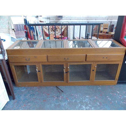 30 - A LARGE PINE SHOP DISPLAY CASE MEASURING APPROX 8' X 2' X 3' 5