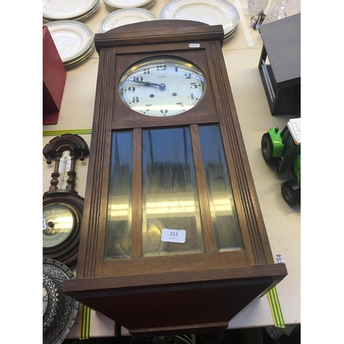 353 - AN OAK WALL CLOCK WITH PENDULUM