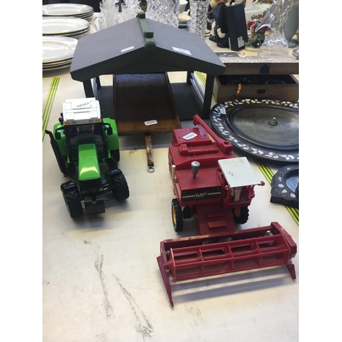 354 - A WOODEN MODEL FARM BUILDING AND TOYS TO INCLUDE MF COMBINE AND A TRACTOR AND TRAILER