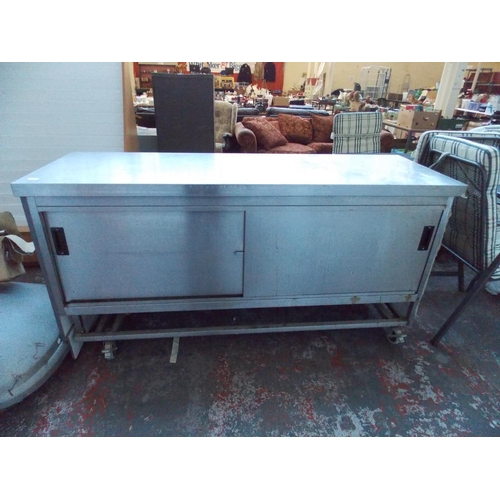 36 - A STAINLESS STEEL INDUSTRIAL KITCHEN WORKSTATION ON WHEELS