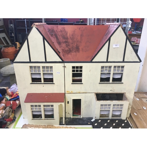 384 - A LARGE VINTAGE DOLLS HOUSE