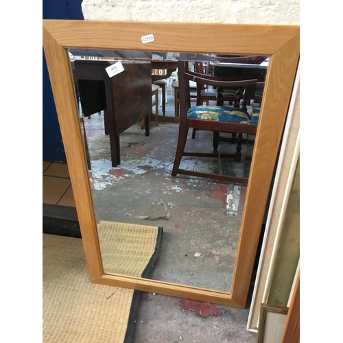 495 - A PINE FRAMED BEVEL EDGED MIRROR