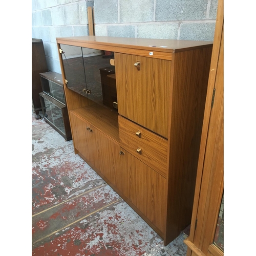 521 - A RETRO SCHREIBER TEAK EFFECT DISPLAY CABINET WITH FOUR DOORS, TWO GLASS DOORS AND A DRAWER