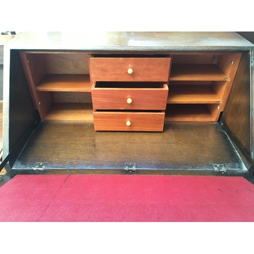 537 - A DARK OAK BUREAU WITH THREE DRAWERS AND A FALL FRONT