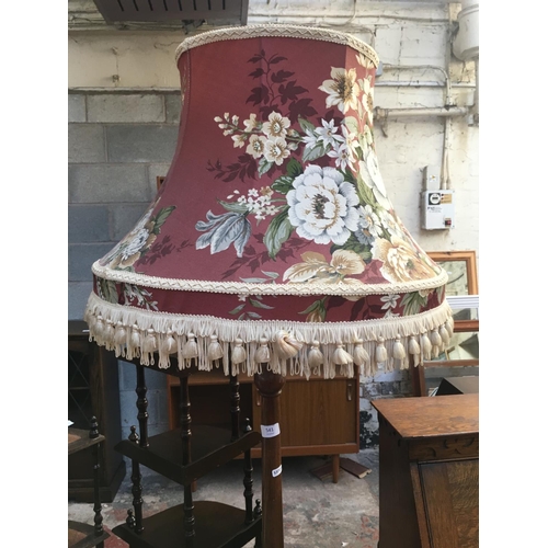 541 - AN OAK STANDARD LAMP WITH FLORAL SHADE