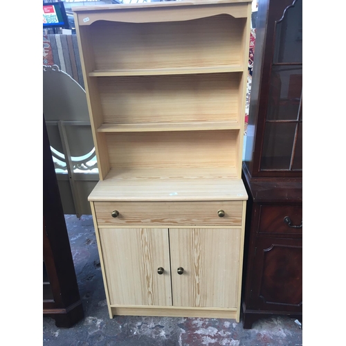 553 - A SMALL PINE EFFECT DRESSER WITH TWO DOORS, ONE DRAWER AND UPPER PLATE RACK