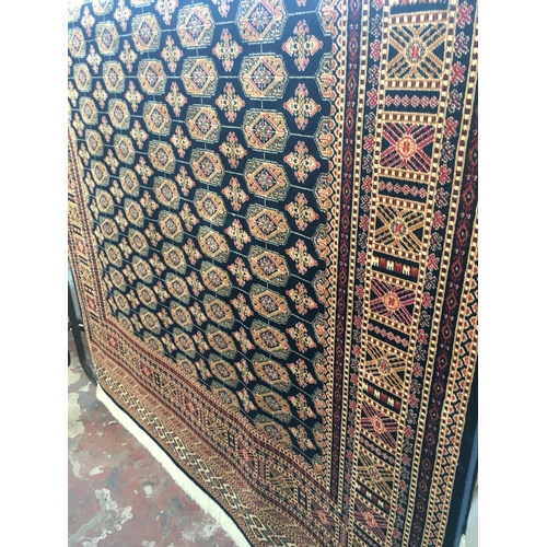 555 - A BLUE GROUND BOKHARA CARPET (MEASURING 2.3  X 1.6 METRES)