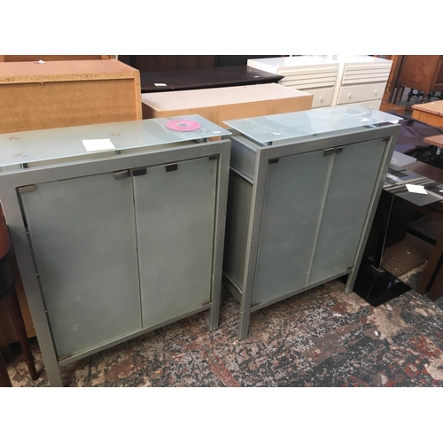 573 - TWO METAL AND GLASS CABINETS