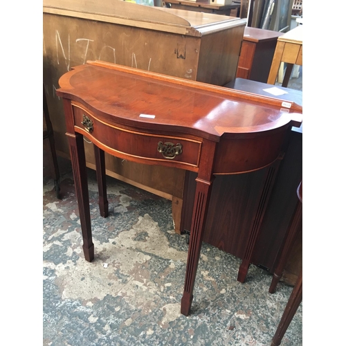 575 - A YEW WOOD SERPENTINE HALL TABLE WITH FLUTED LEGS