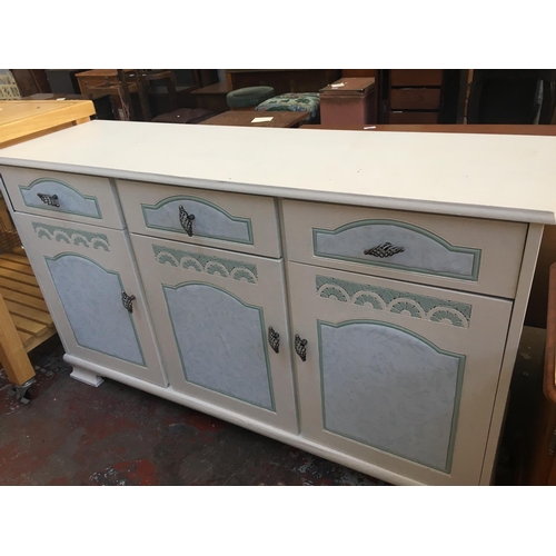 584 - TWO ITEMS TO INCLUDE A PINE TV STAND AND A WHITE PAINTED SIDEBOARD WITH THREE DRAWERS AND THREE DOOR... 