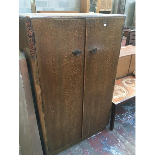 587 - AN ART DECO OAK DOUBLE WARDROBE