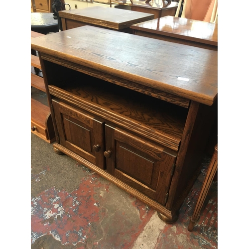 589 - AN OAK CABINET WITH TWO DOORS