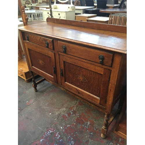 591 - AN ART DECO OAK SIDEBOARD WITH TWO DOORS AND TWO DRAWERS