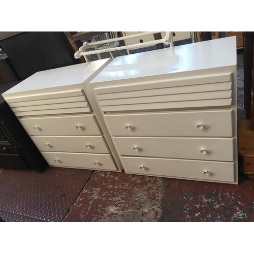 593 - A PAIR OF WHITE PAINTED CHESTS OF FOUR DRAWERS