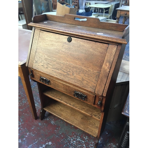 595 - AN OAK LADIES BUREAU WITH ONE DRAWER, TWO SHELVES AND A FALL FRONT