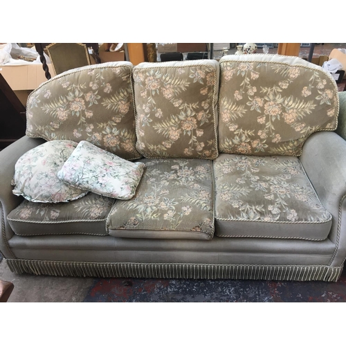 649A - A GREEN DRALON THREE SEATER SOFA