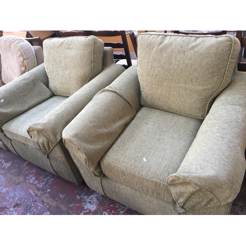 649B - A PAIR OF GREEN UPHOLSTERED ARM CHAIRS