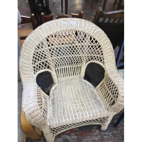 654 - A WHITE PAINTED WICKER CHAIR