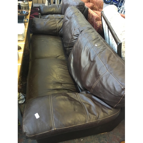 659 - A BROWN LEATHER THREE SEATER SOFA AND A MATCHING ARMCHAIR