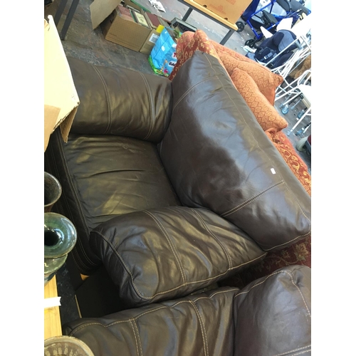 659 - A BROWN LEATHER THREE SEATER SOFA AND A MATCHING ARMCHAIR