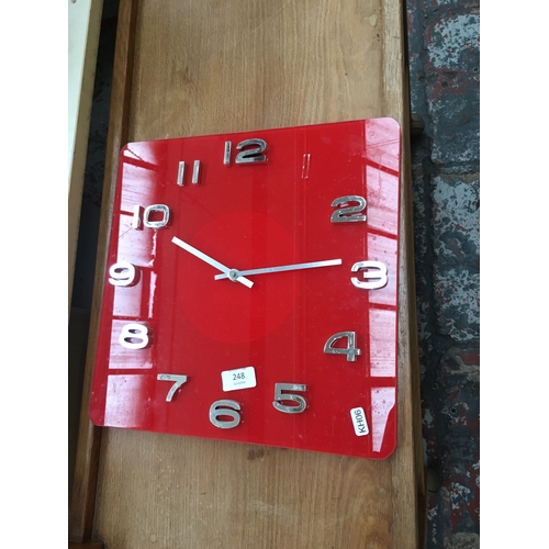 248 - A MAHOGANY WALL CLOCK AND A RED WALL CLOCK