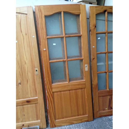 27 - THREE PINE INTERIOR DOORS WITH SIX GLASS PANELS PER DOOR -  MEASURING APPROX 77