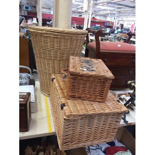 349 - A WICKER LINEN BASKET AND TWO WICKER STORAGE BASKETS