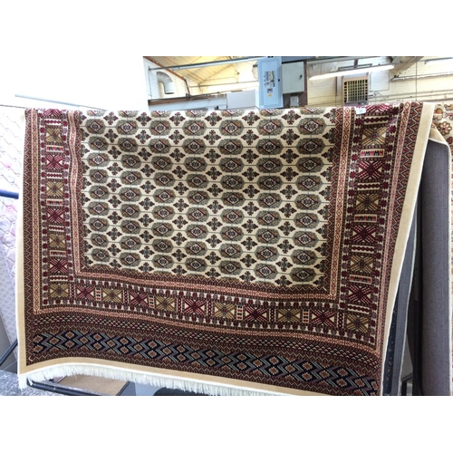 721 - A BEIGE GROUND BOKHARA CARPET MEASURING 2.8m x 2.0m