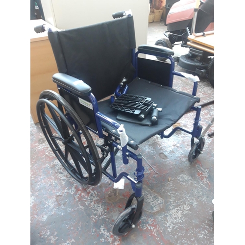 39 - A GOOD QUALITY NEW BLUE METAL WHEELCHAIR WITH PLASTIC WHEELS AND FOOT RESTS