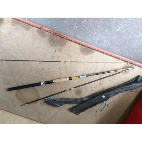 61 - TWO ITEMS TO INCLUDE A RED DOMYOS PUNCH BAG AND A DAIWA FISHER 9 THREE PIECE FISHING ROD