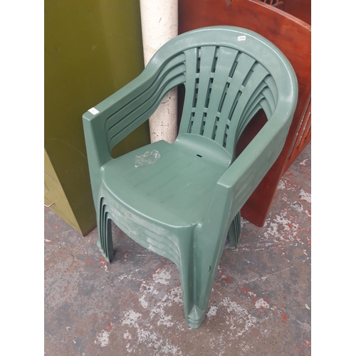 35 - FOUR GREEN PLASTIC STACKABLE GARDEN CHAIRS