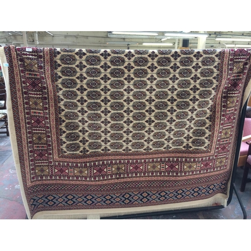 566 - A BEIGE GROUND BOKHARA CARPET MEASURING 2.8m x 2.0m