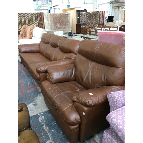 573 - A GOOD QUALITY BROWN LEATHER THREE SEATER SOFA AND MATCHING ARMCHAIR