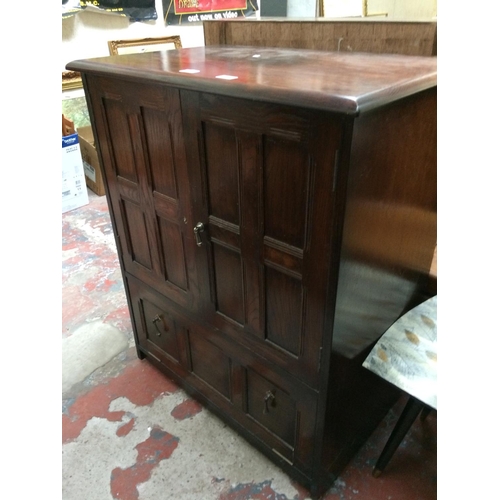 610 - AN OAK TV CABINET WITH TWO DOORS AND ONE DRAWER