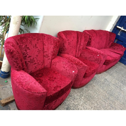 683 - A BURGUNDY UPHOLSTERED THREE SEATER SOFA AND TWO MATCHING CHAIRS