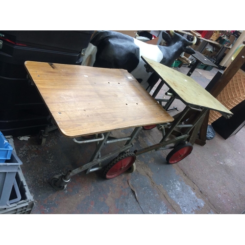 170 - TWO GREY METAL FOUR WHEELED WAREHOUSE TABLES