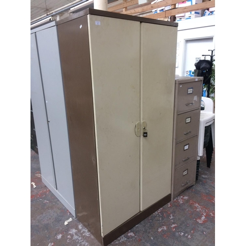 29 - A BISLEY BROWN AND CREAM METAL TWO DOOR OFFICE STORAGE CABINET WITH KEY