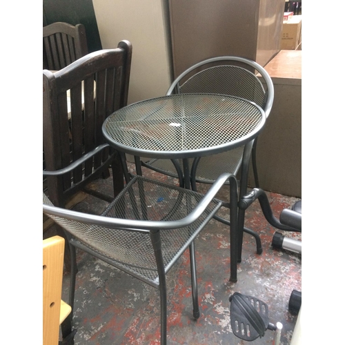 39 - A THREE PIECE GREY METAL MESHED PATIO SET COMPRISING OF A CIRCULAR PEDESTAL TABLE AND TWO MATCHING A... 